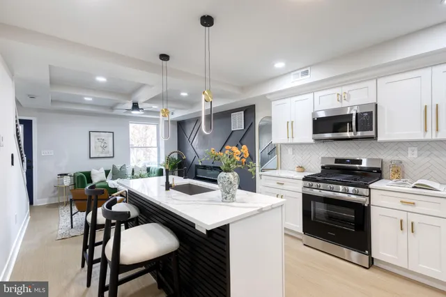 a kitchen with a stove a sink and a refrigerator