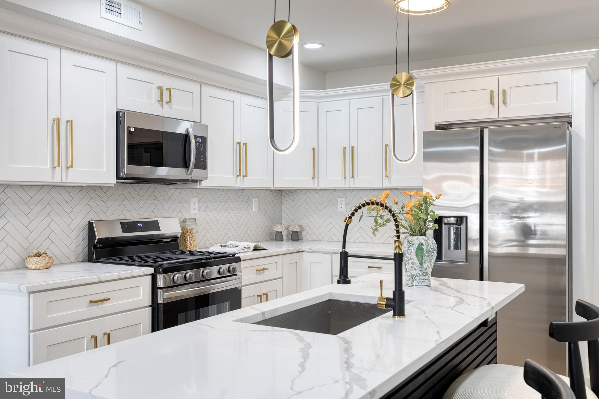 3721 Manchester Avenue Baltimore, MD 21215 - Photo 18 of 36 a kitchen with granite countertop a stove a sink and a microwave