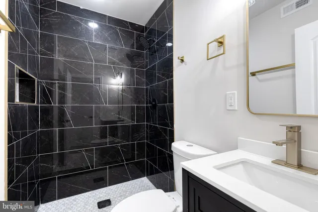 a bathroom with a sink toilet and shower