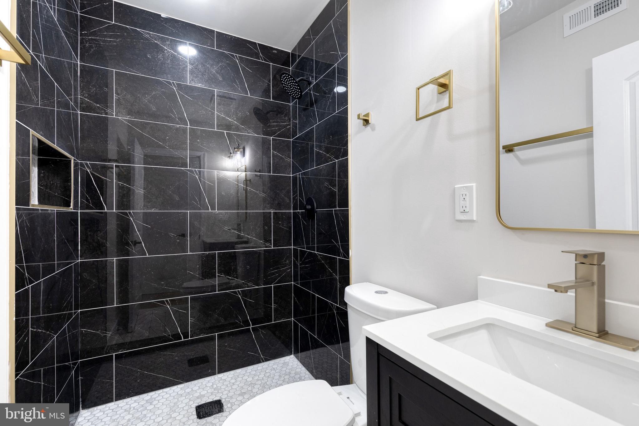 3721 Manchester Avenue Baltimore, MD 21215 - Photo 21 of 36 a bathroom with a sink toilet and shower