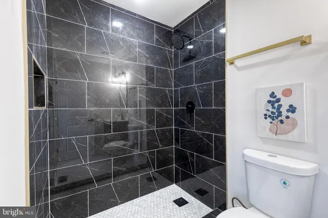 a bathroom with a toilet and a shower