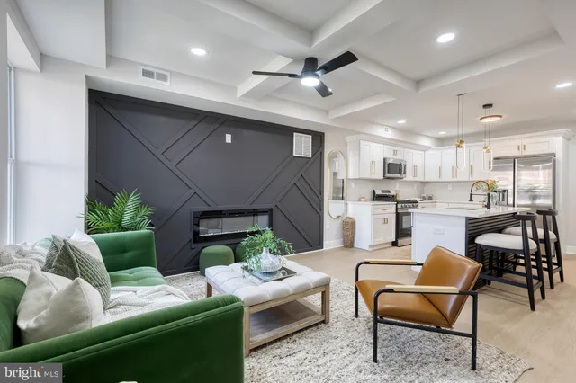 a living room with furniture and a kitchen view