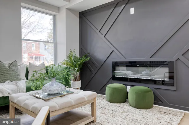 a living room with furniture and a potted plant