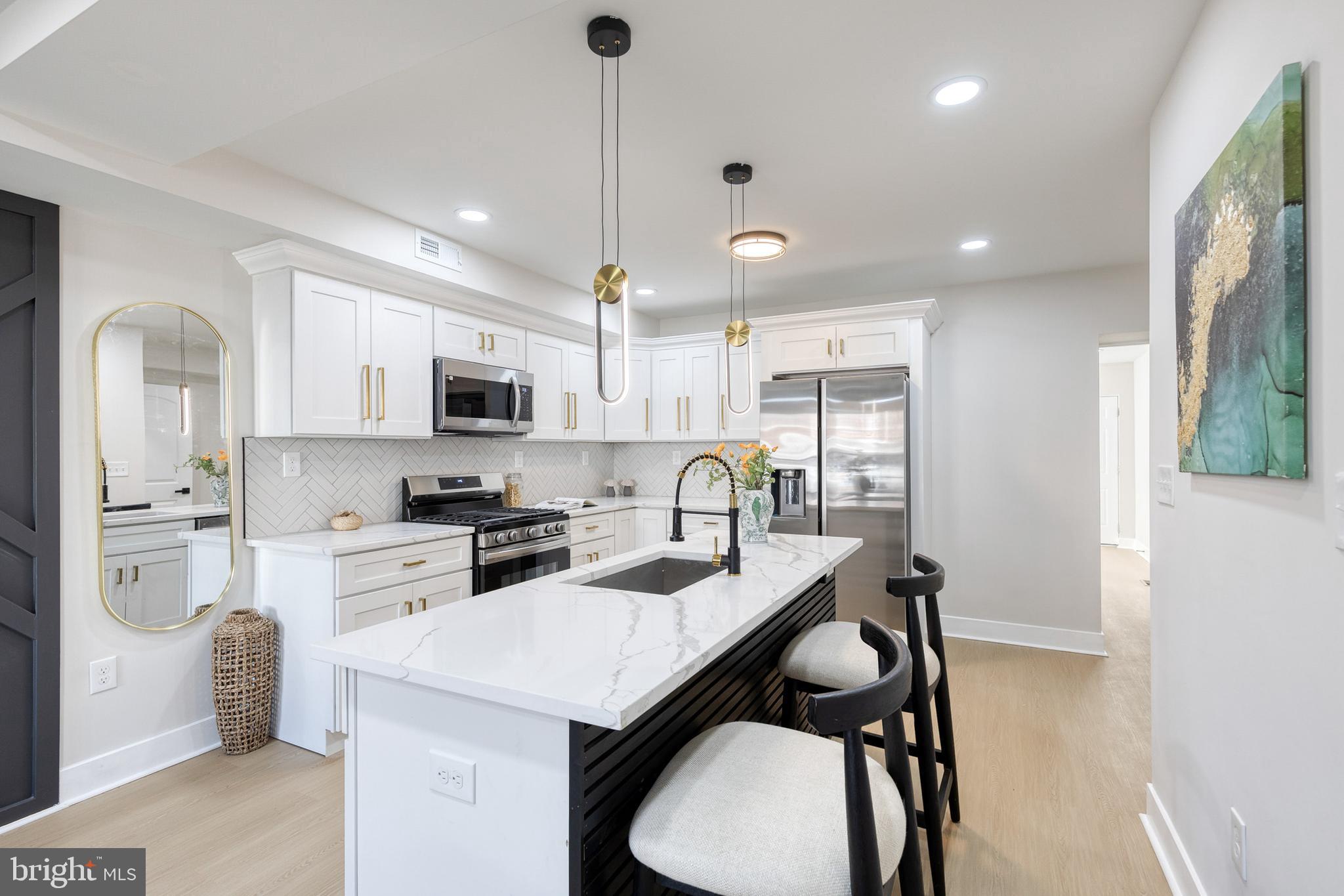 3721 Manchester Avenue Baltimore, MD 21215 - Photo 10 of 36 a kitchen with granite countertop a sink a stove a refrigerator a stove a dining table and chairs
