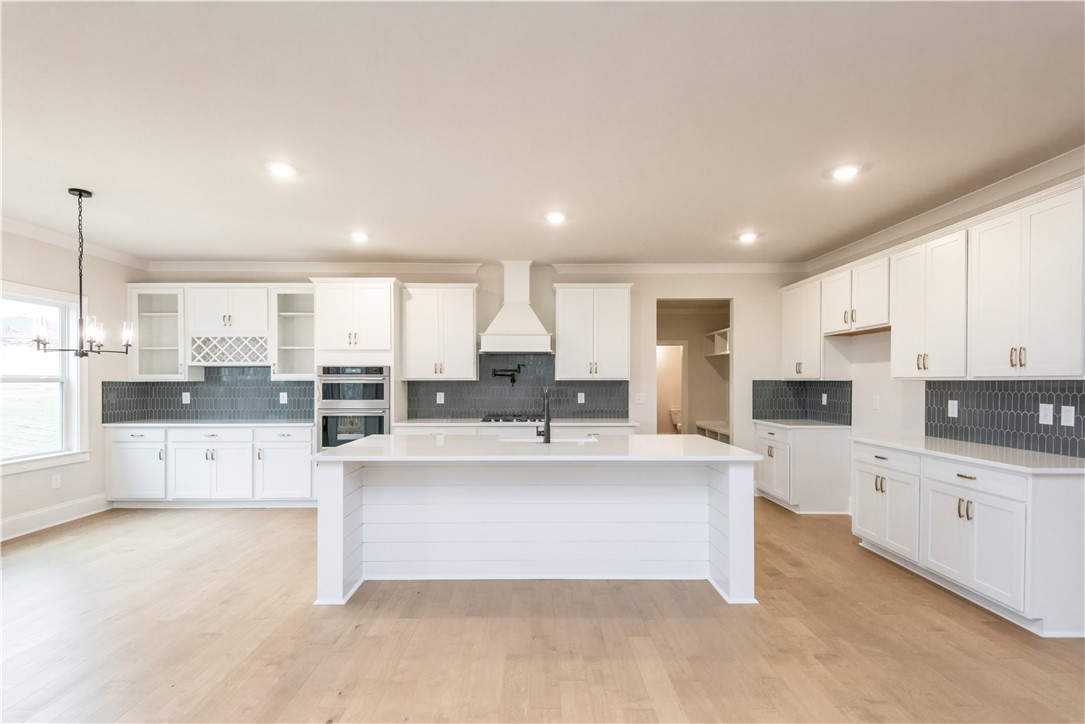 222 Holly Br Road Piedmont, SC 29673 - Photo 11 of 31 Bright and airy, this kitchen features sleek white cabinetry and an inviting island perfect for gathering.