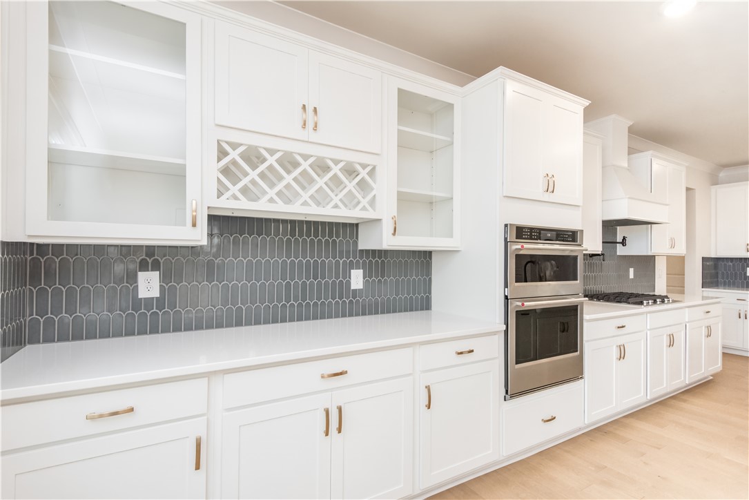222 Holly Br Road Piedmont, SC 29673 - Photo 12 of 31 This modern kitchen features crisp white cabinetry and sleek built-in appliances.