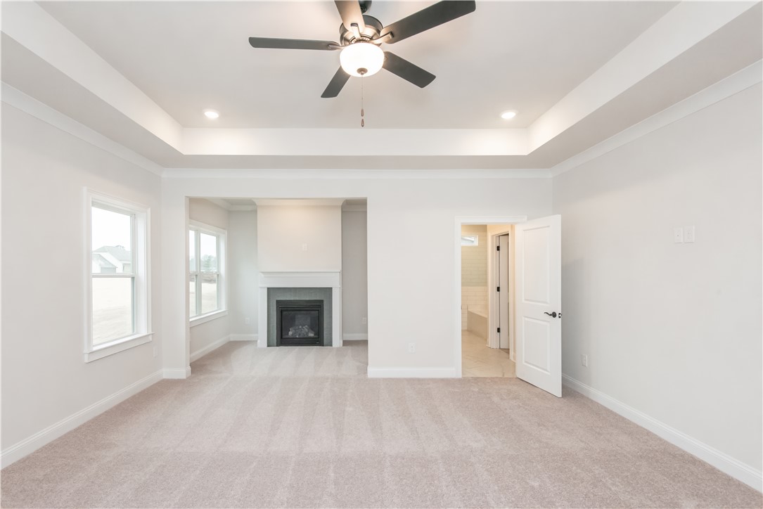 222 Holly Br Road Piedmont, SC 29673 - Photo 20 of 31 This expansive primary bedroom offers a serene retreat with an elegant fireplace.