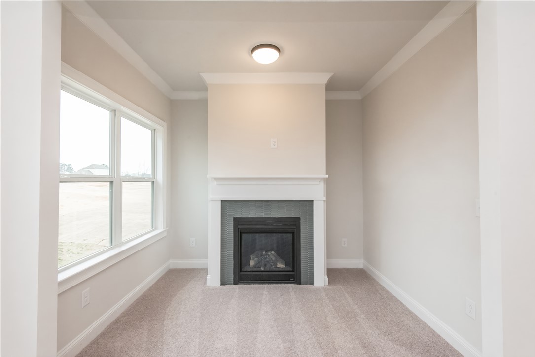 222 Holly Br Road Piedmont, SC 29673 - Photo 21 of 31 This cozy living space features a fireplace and crown molding, perfect for relaxation and gathering.