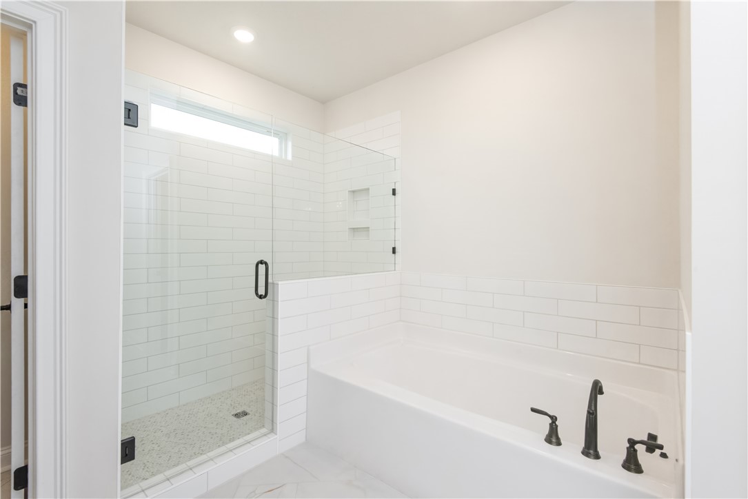 222 Holly Br Road Piedmont, SC 29673 - Photo 24 of 31 This bright bathroom features clean tile work, a modern shower, and a pristine soaking tub.