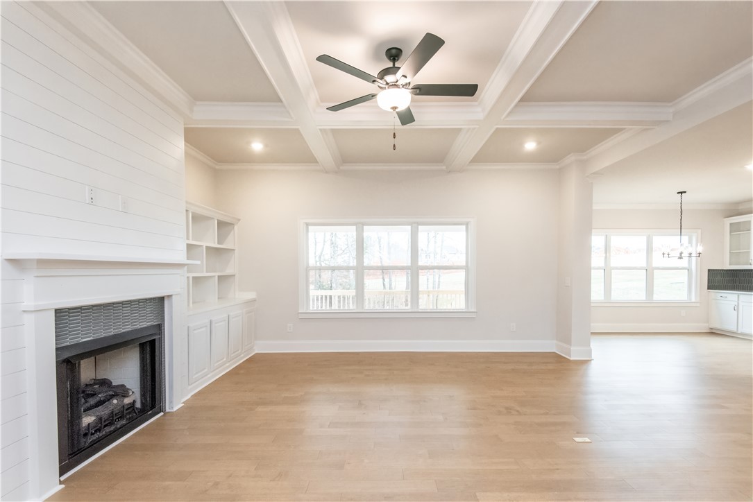 222 Holly Br Road Piedmont, SC 29673 - Photo 8 of 31 This bright living space features hardwood floors, a cozy fireplace, and custom built-in shelving.