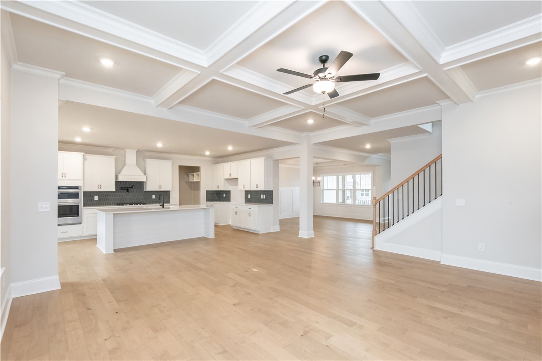 222 Holly Br Road Piedmont, SC 29673 - Photo 10 of 31 This expansive open-concept living space features a modern kitchen and elegant coffered ceilings.