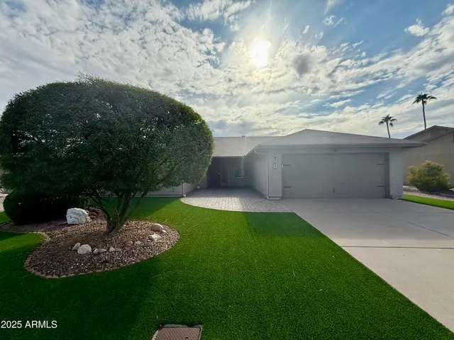 a view of a backyard with plants and outdoor seating