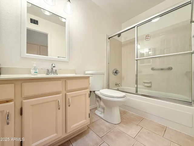 a bathroom with a toilet sink and shower