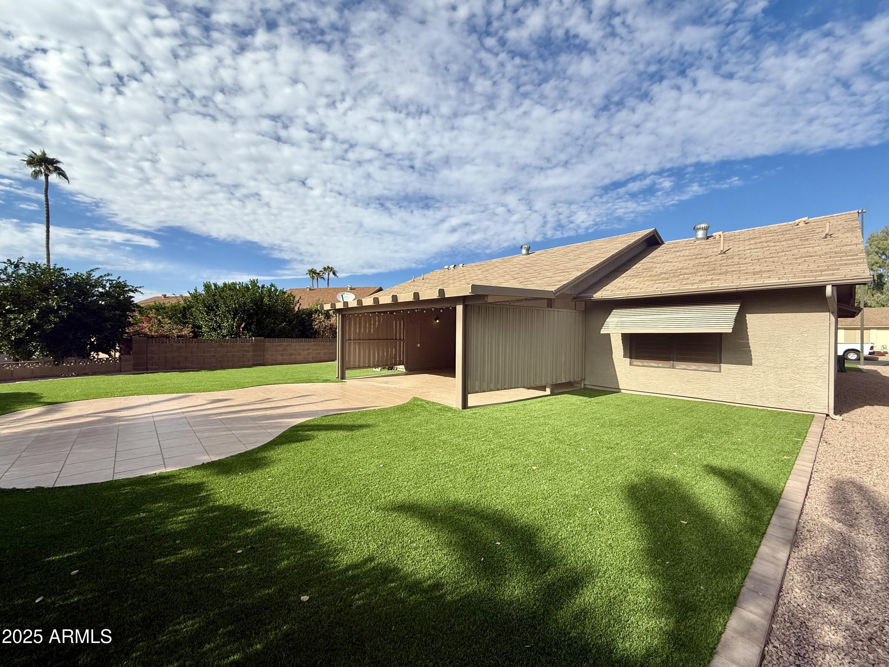 7641 East Pueblo Avenue Mesa, AZ 85208 - Photo 19 of 20 a view of yard with swimming pool and green space