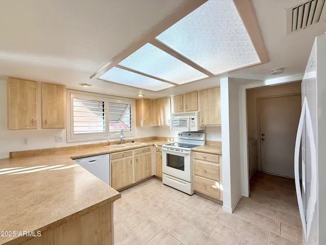a kitchen with stainless steel appliances granite countertop a stove and a refrigerator