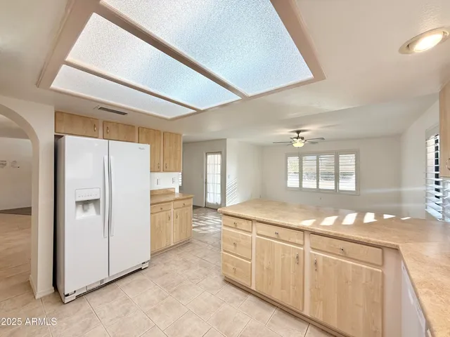 a kitchen with granite countertop cabinets and refrigerator