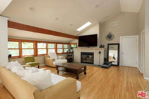 a living room with furniture flat screen tv and a fireplace