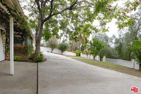 a view of a road with a wrought fence