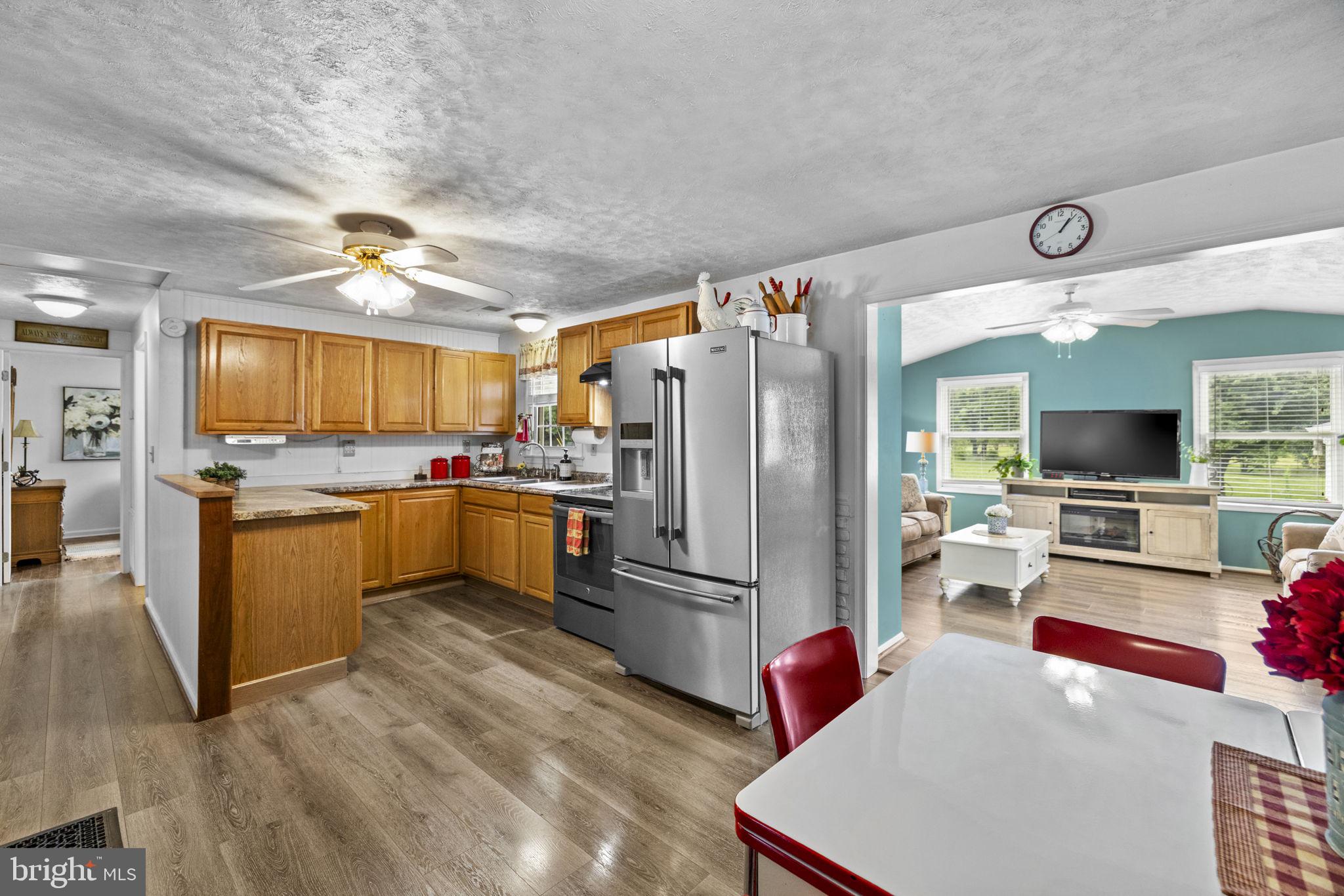 171 Triple J Road Berryville, VA 22611 - Photo 19 of 95 Sunny kitchen w/ hardwood cabinets & SS fridge.