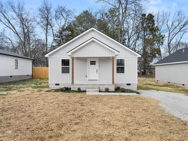a view of a house with a yard covered in snow