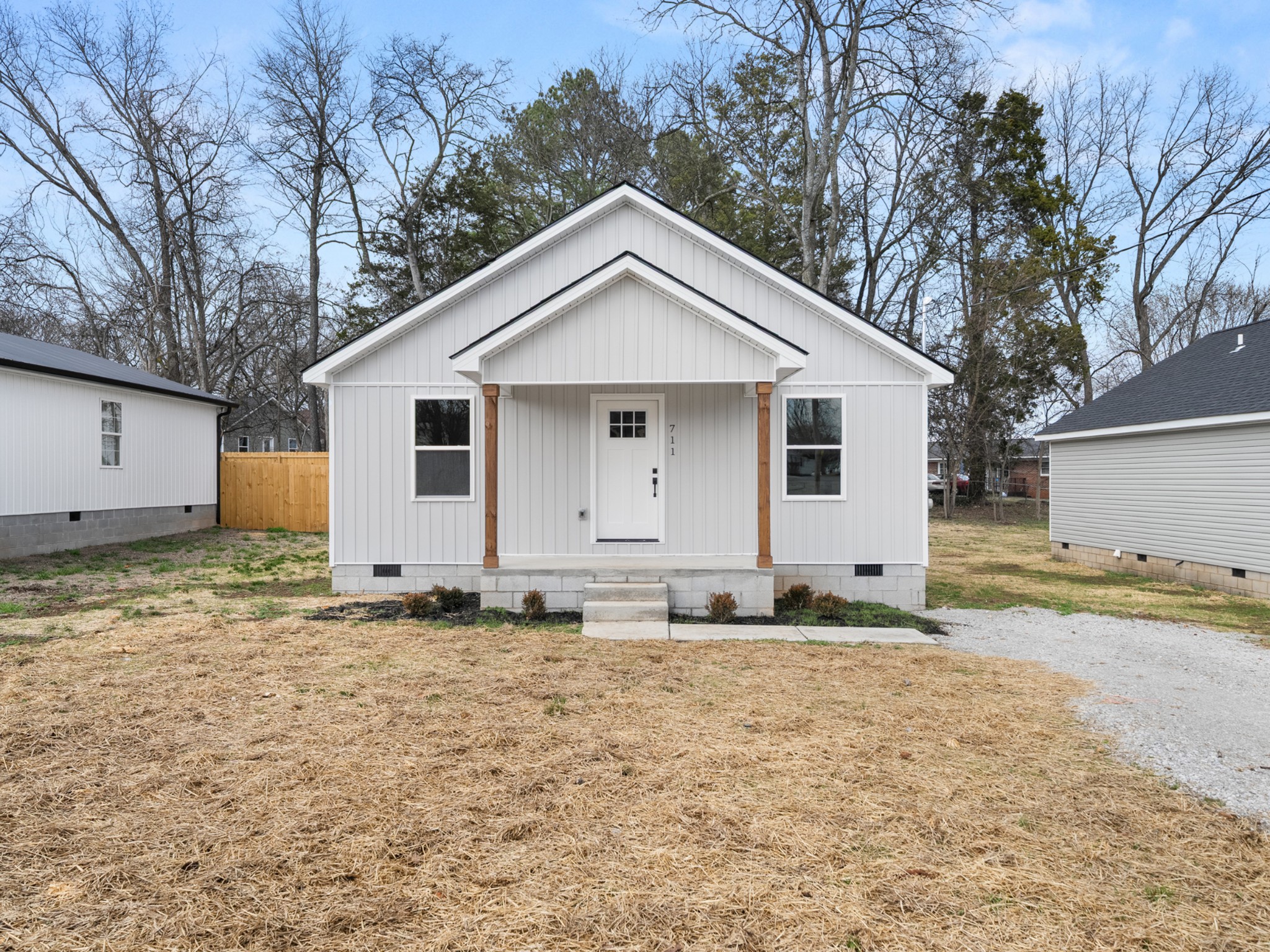 a view of a house with a yard covered in snow