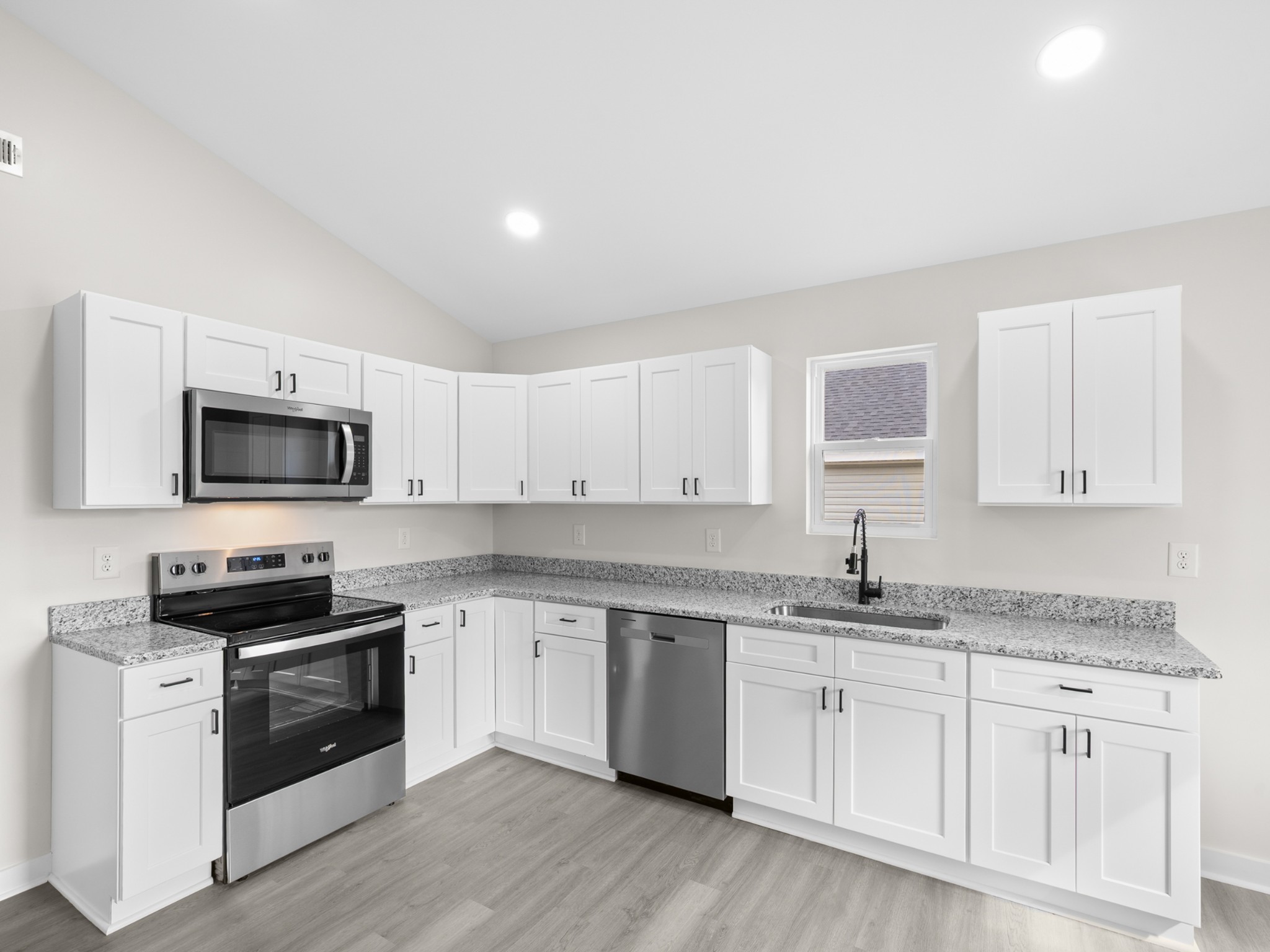 711 Hunt Street Winchester, TN 37398 - Photo 11 of 30 a kitchen with white cabinets stainless steel appliances and sink
