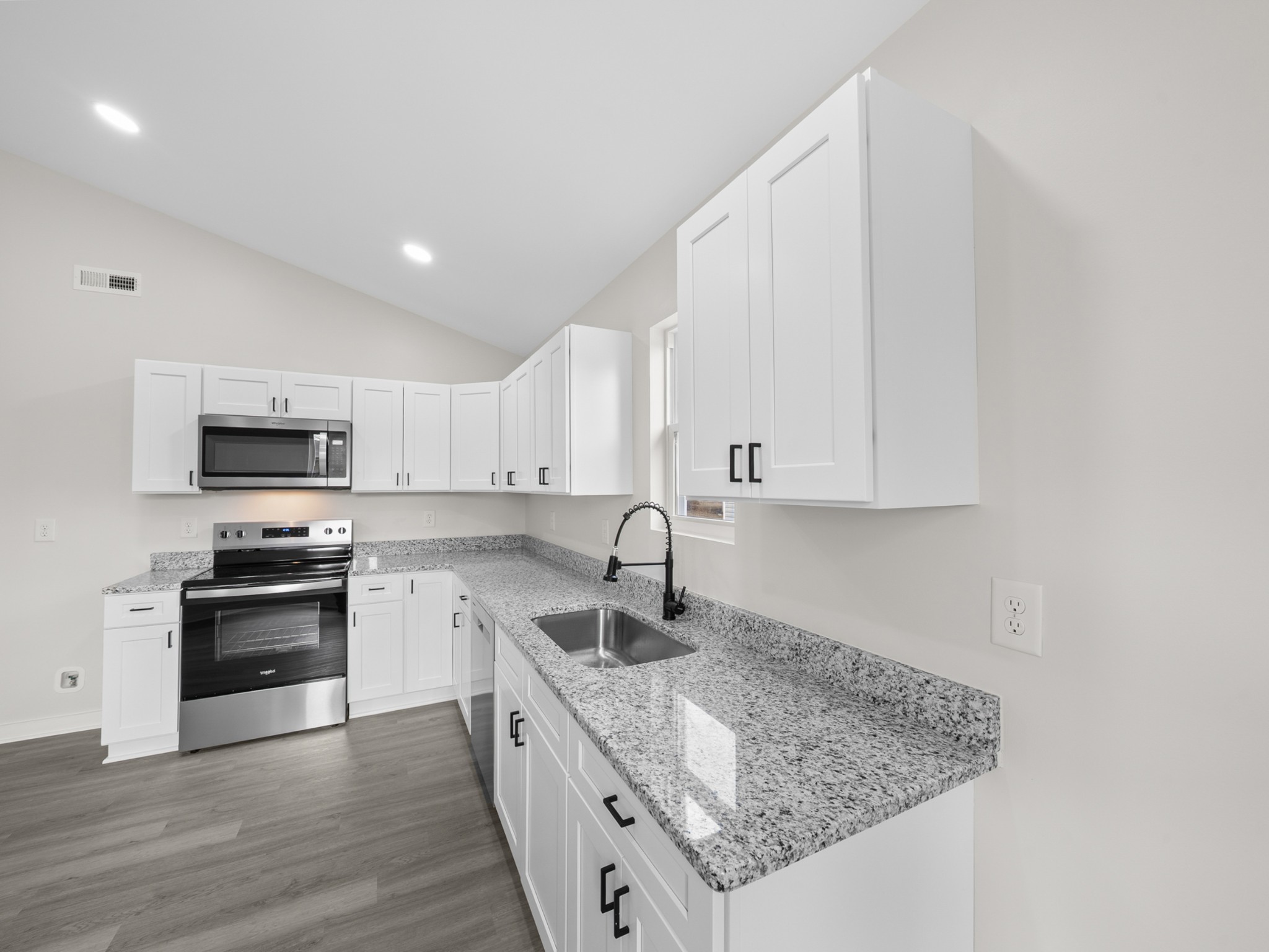 711 Hunt Street Winchester, TN 37398 - Photo 12 of 30 a kitchen with stainless steel appliances granite countertop a sink stove and microwave