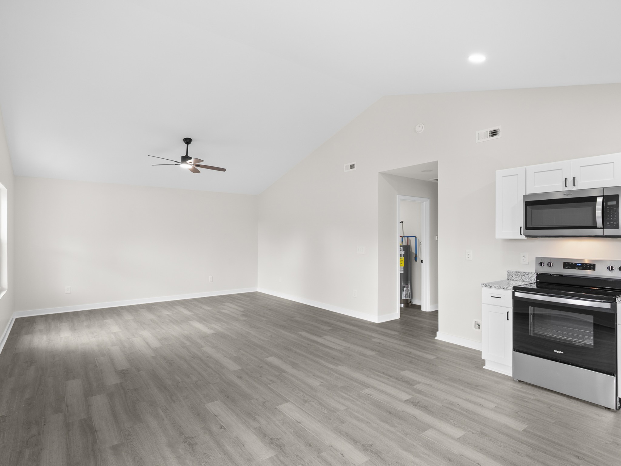 711 Hunt Street Winchester, TN 37398 - Photo 15 of 30 a view of empty room with wooden floor and kitchen