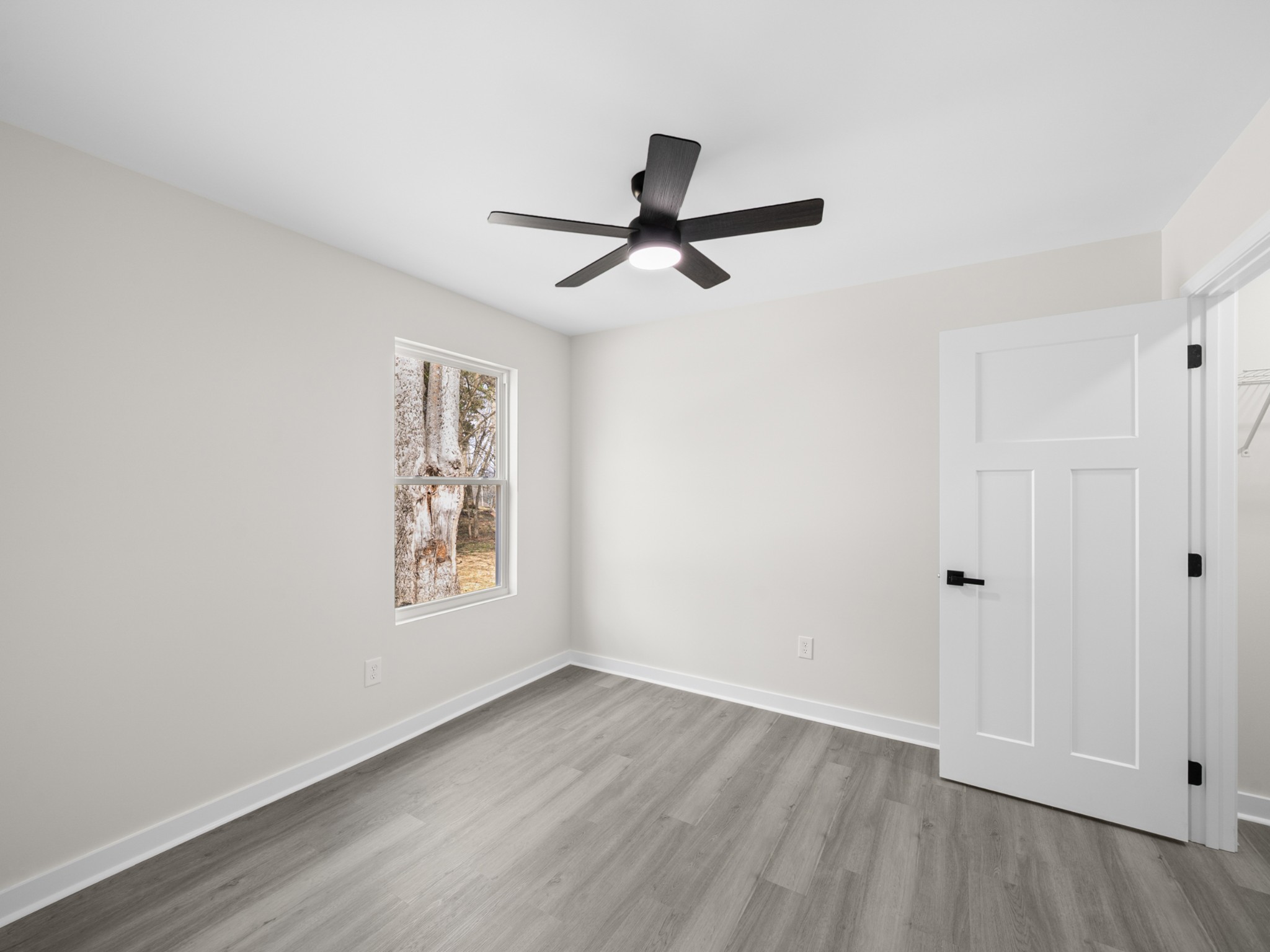 711 Hunt Street Winchester, TN 37398 - Photo 19 of 30 an empty room with wooden floor ceiling fan and windows