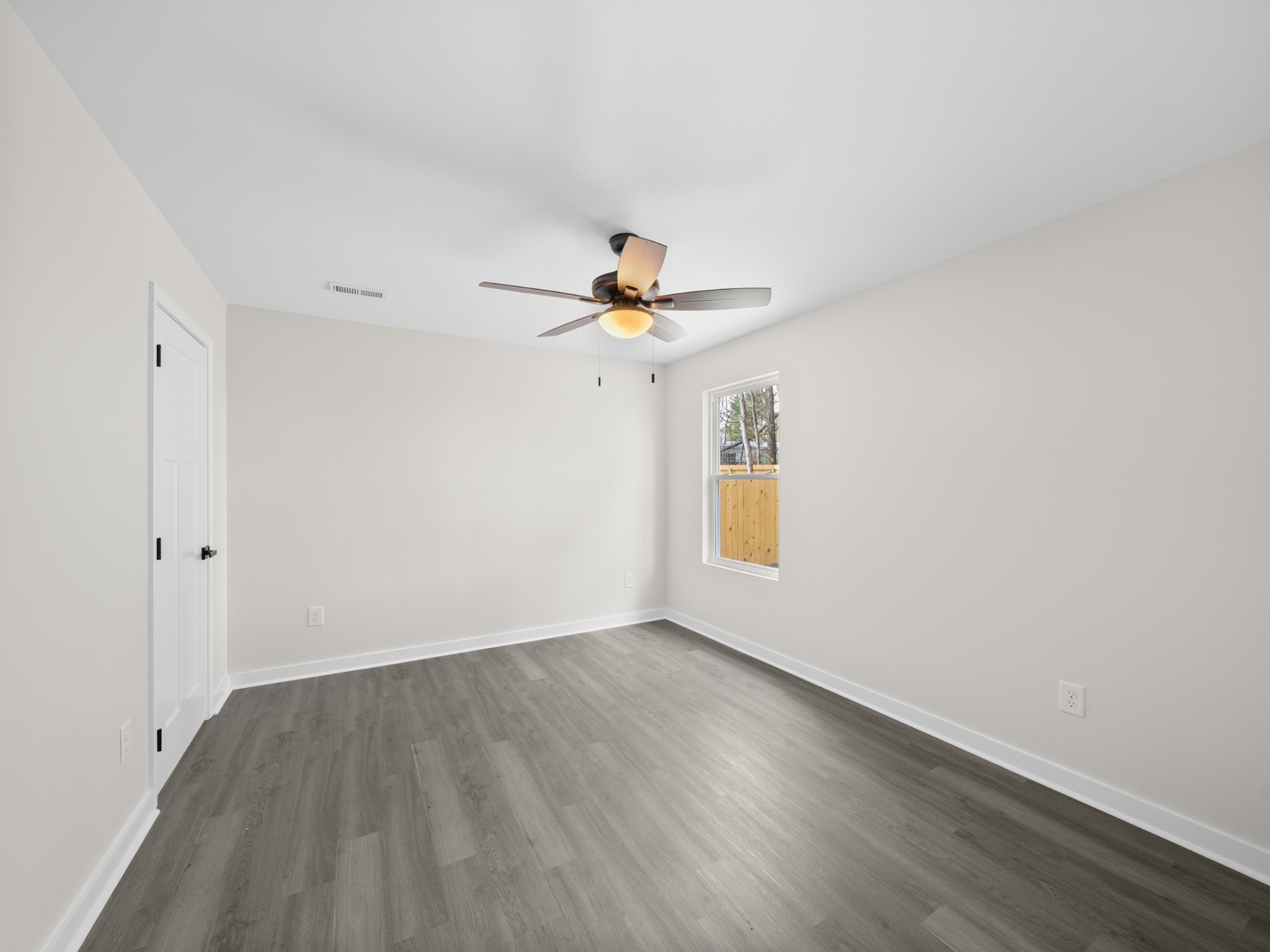 711 Hunt Street Winchester, TN 37398 - Photo 21 of 30 a view of room with window and wooden floor