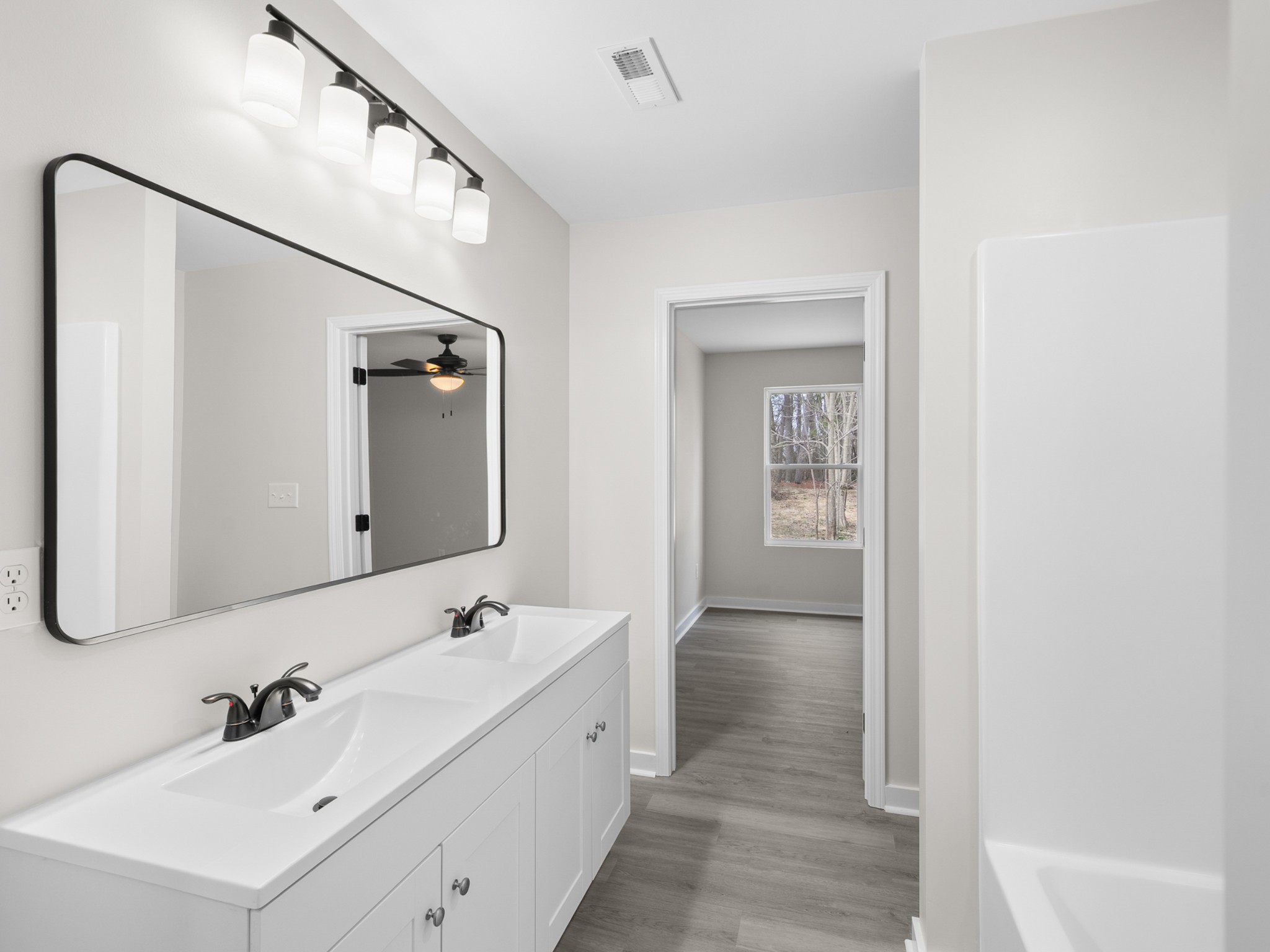 711 Hunt Street Winchester, TN 37398 - Photo 24 of 30 a bathroom with a double vanity sink and mirror