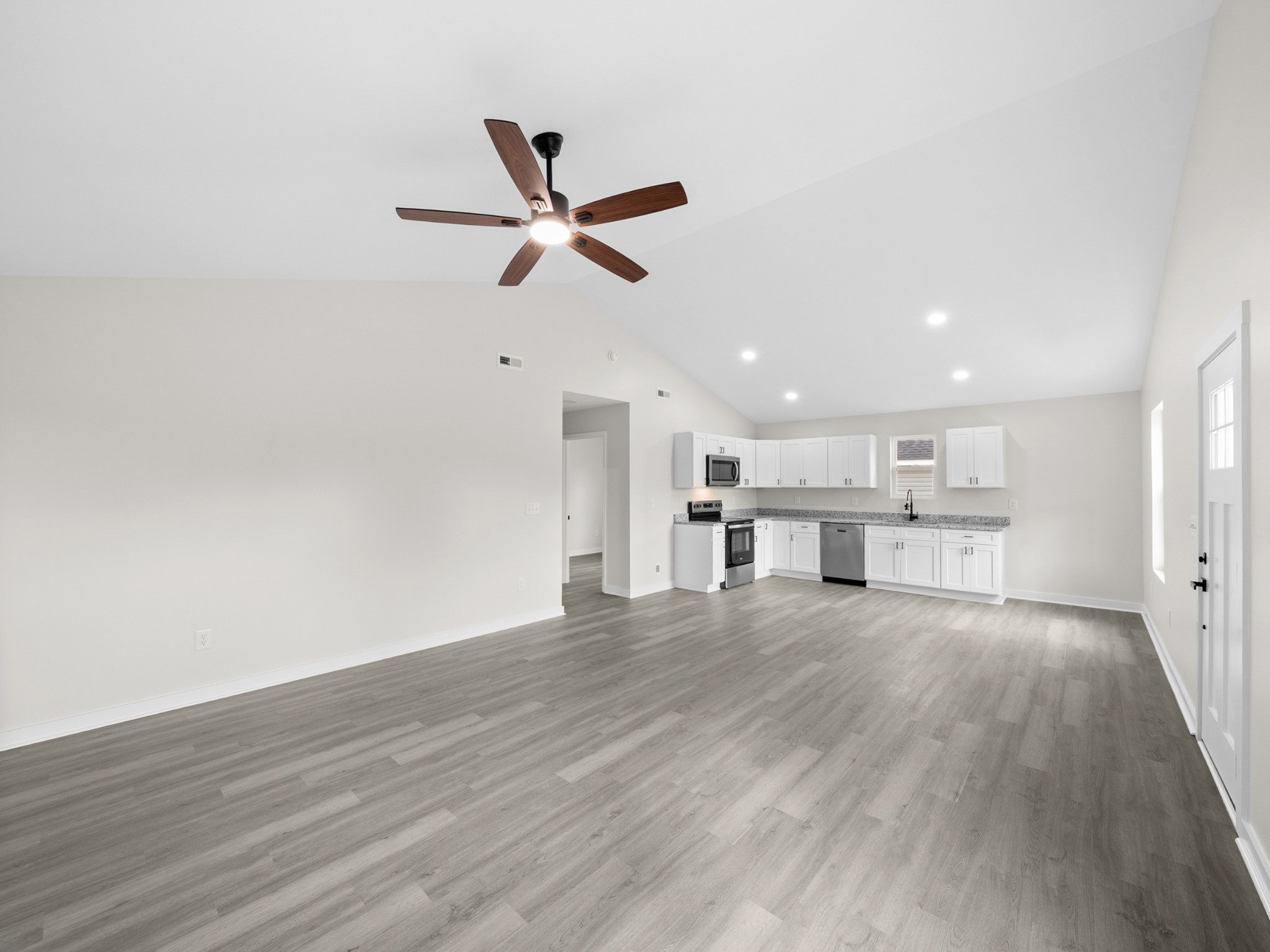 711 Hunt Street Winchester, TN 37398 - Photo 10 of 30 a view of a kitchen with wooden floor and window