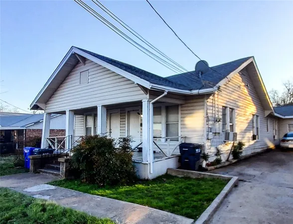 a view of a house with a cars park