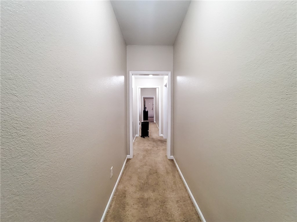 1202 North 9th Street Waco, TX 76707 - Photo 7 of 10 a view of a hallway with wooden floor and a bathroom