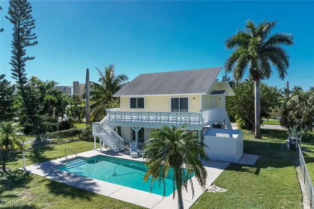 a front view of house with yard and outdoor seating
