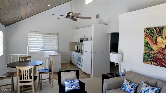 a view of a livingroom with furniture and a window