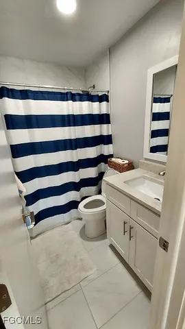 a bathroom with a sink toilet and vanity