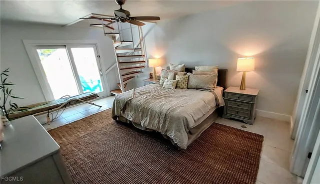 a bedroom with a bed and a mirror on the dresser