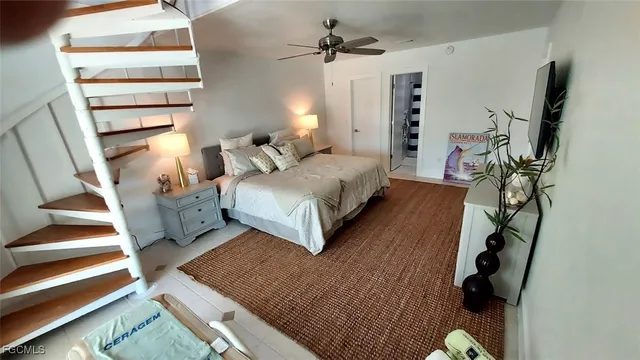 a bed room with a bed window and a potted plant