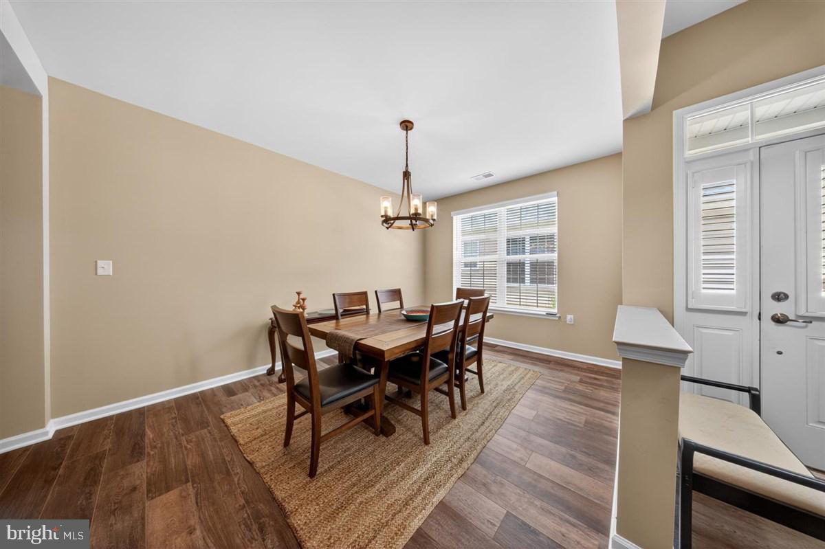1426 Whispering Woods Road Middletown, DE 19709 - Photo 4 of 37 a view of a dining room with furniture window and wooden floor