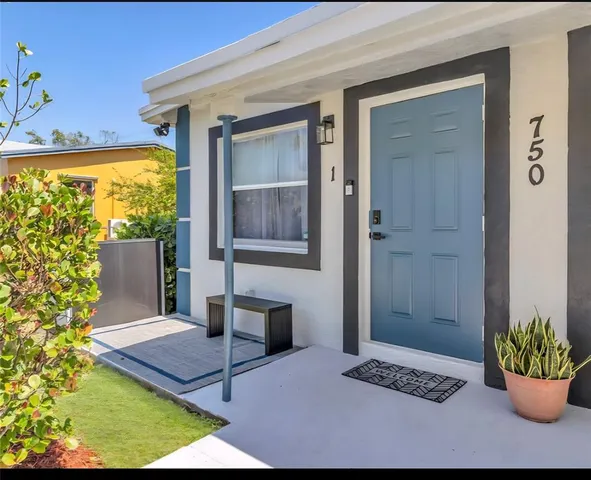 a balcony with furniture and a potted plant