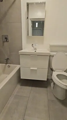 a bathroom with a bathtub sink and toilet