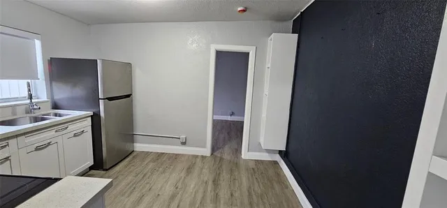 a kitchen with a sink and refrigerator