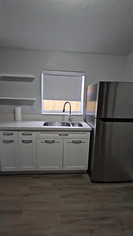 a kitchen with a sink and refrigerator