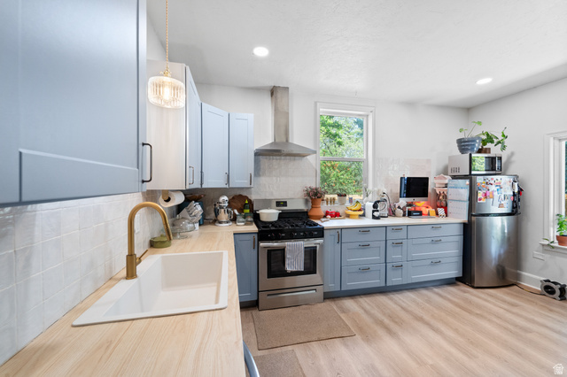 257 200 South Provo, UT 84606 - Photo 7 of 40 Kitchen with light countertops, stainless steel appliances, tasteful backsplash, light wood-style floors, and recessed lighting
