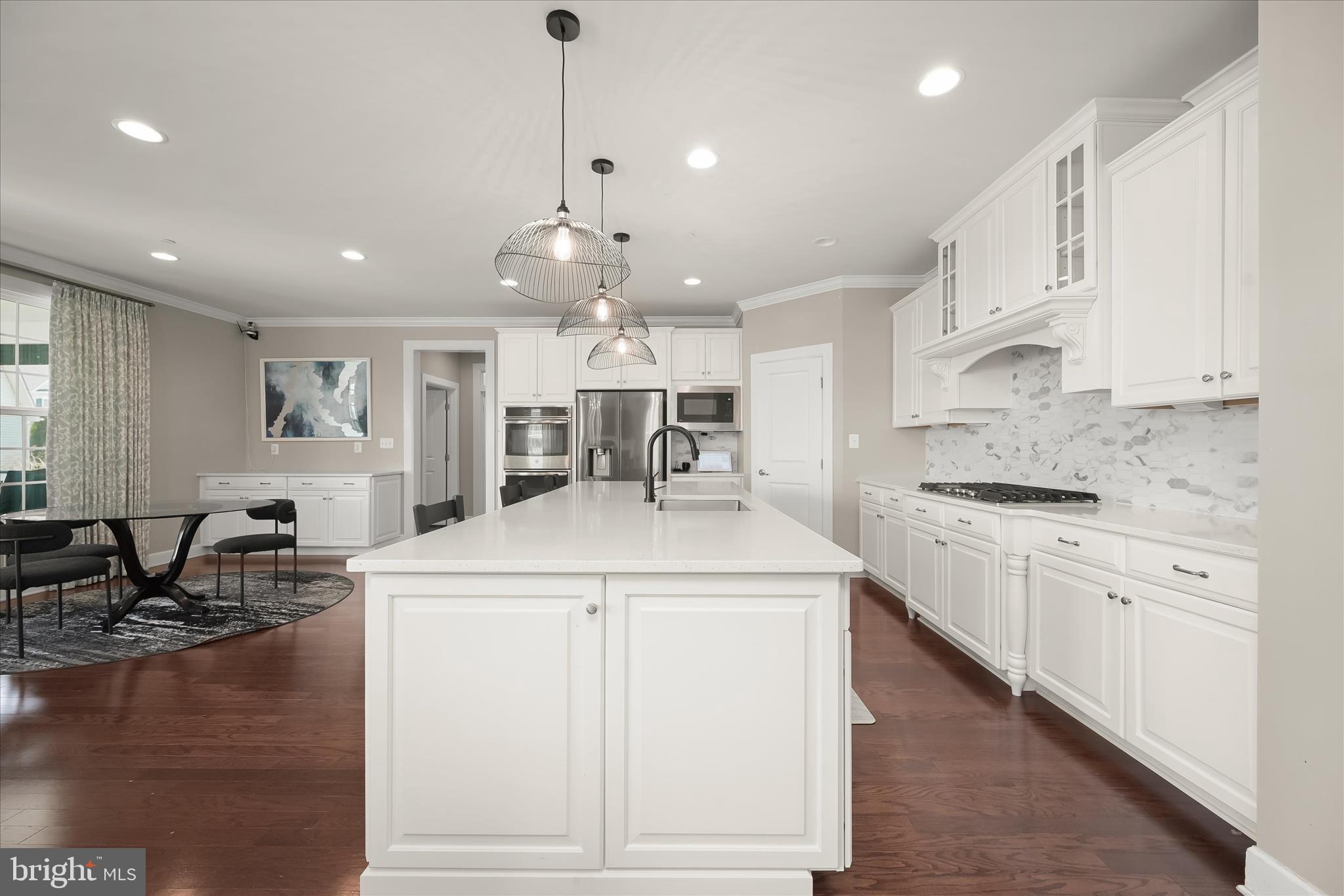 11047 Martha Way Fulton, MD 20759 - Photo 15 of 87 a kitchen with stainless steel appliances kitchen island granite countertop a sink and cabinets