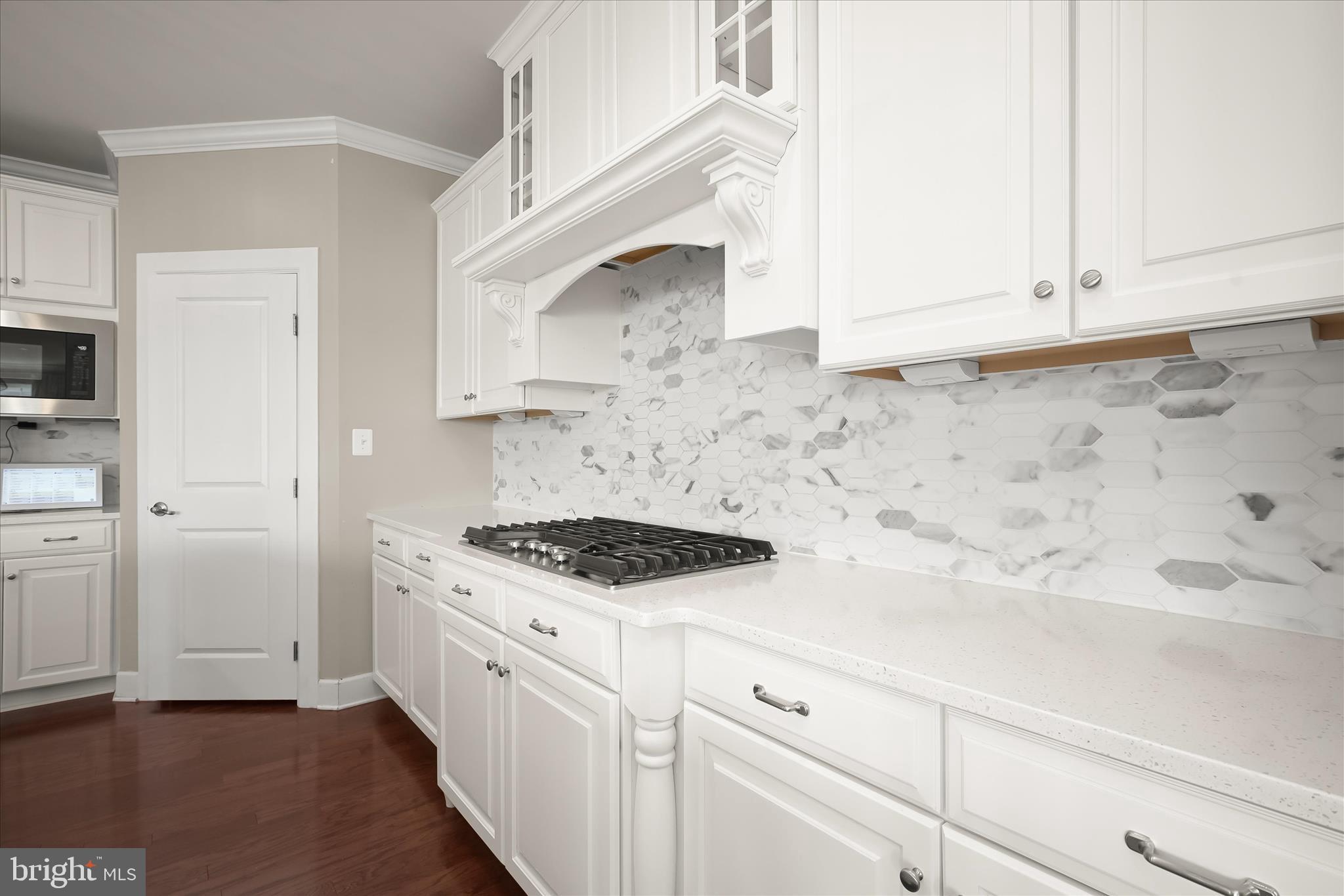 11047 Martha Way Fulton, MD 20759 - Photo 15 of 80 a kitchen with white cabinets and white appliances