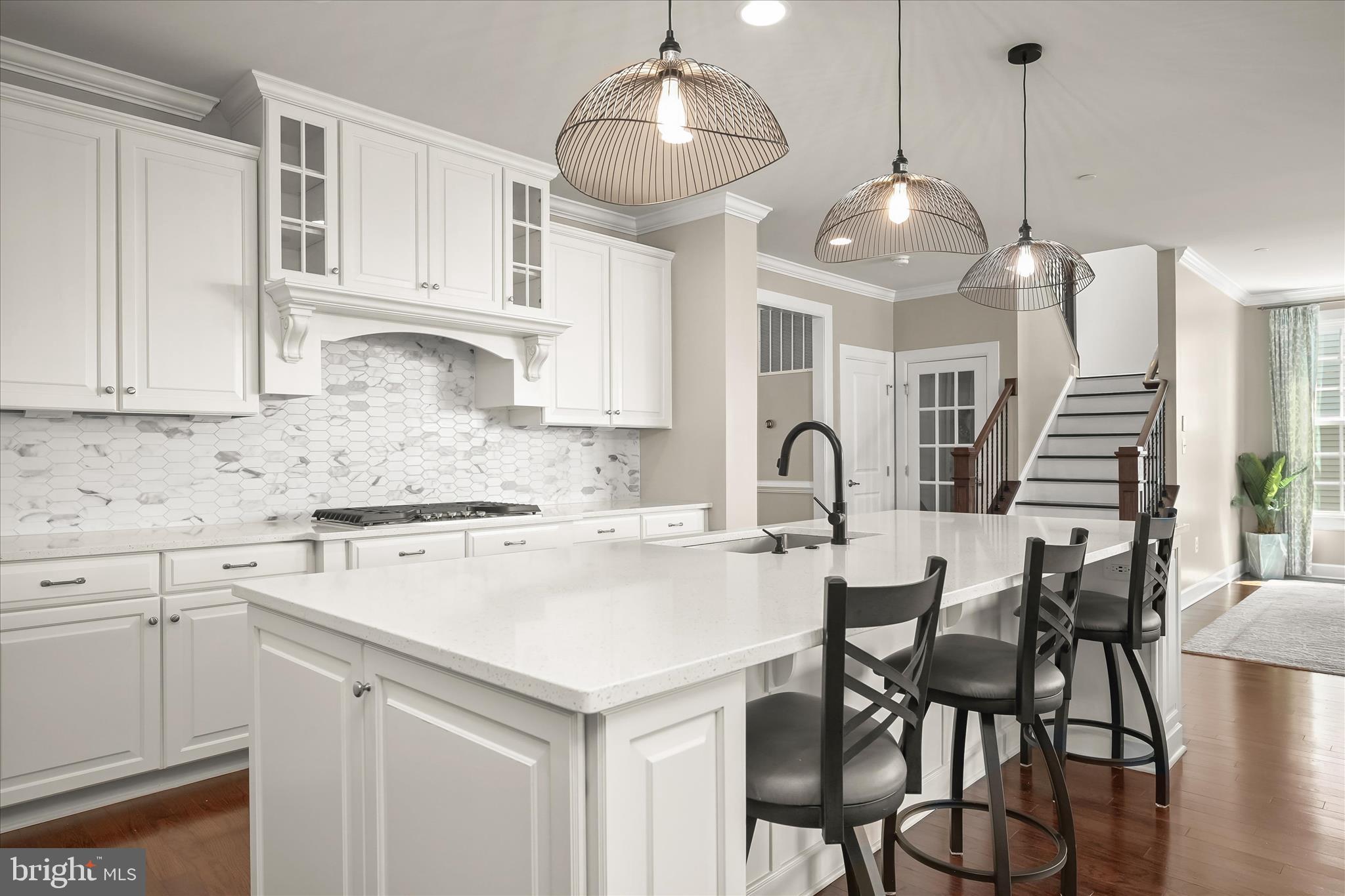 11047 Martha Way Fulton, MD 20759 - Photo 19 of 87 a kitchen with stainless steel appliances a table chairs and white cabinets