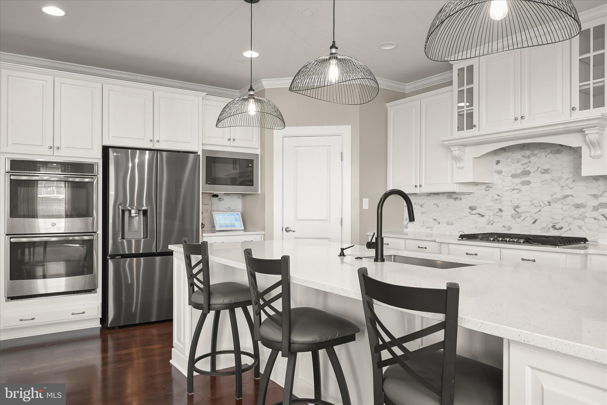 11047 Martha Way Fulton, MD 20759 - Photo 20 of 80 a kitchen with stainless steel appliances granite countertop a dining table chairs refrigerator and cabinets