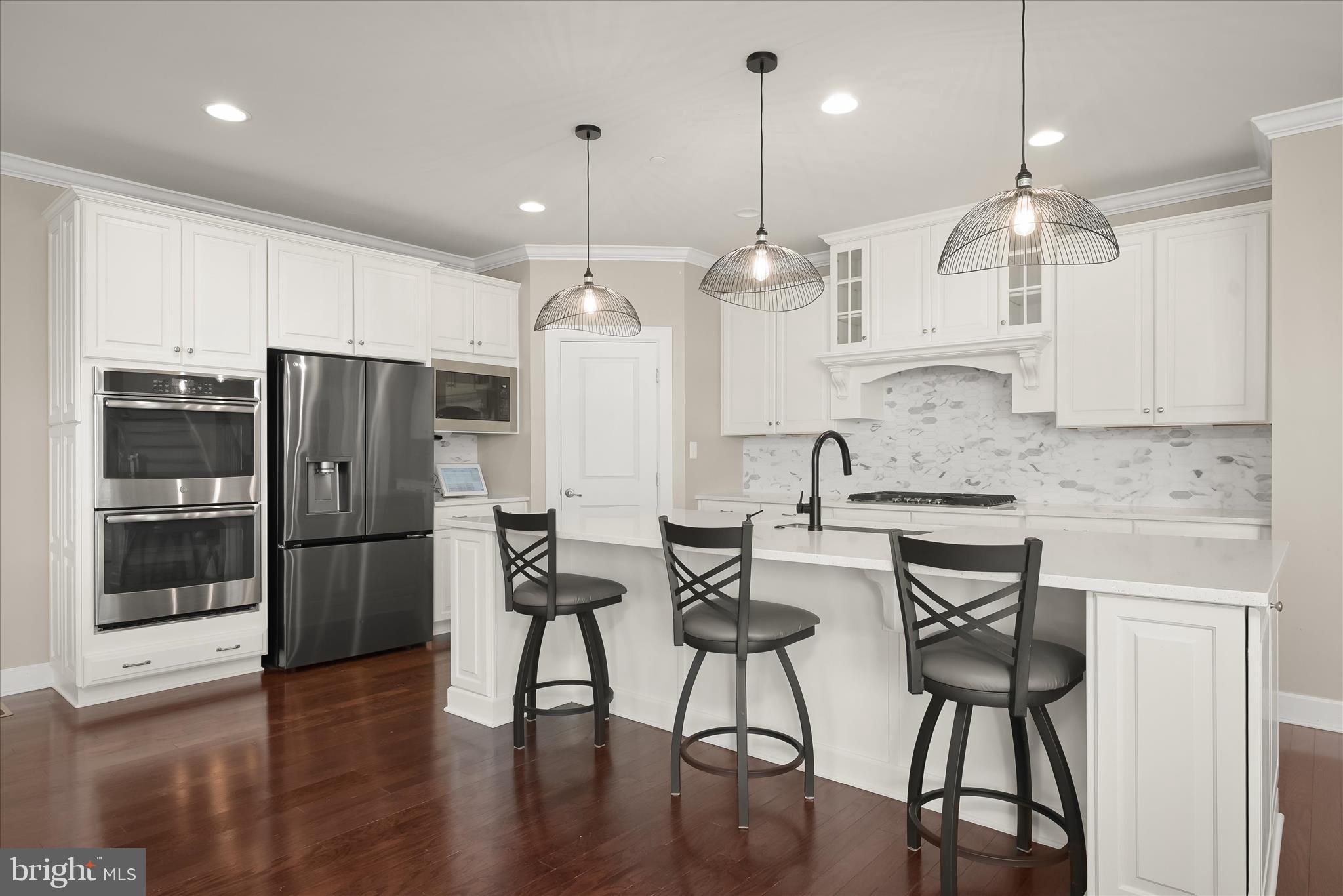 11047 Martha Way Fulton, MD 20759 - Photo 20 of 87 a large kitchen with stainless steel appliances kitchen island granite countertop a dining table chairs and sink
